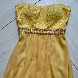 Strapless long yellow gown with sequined waistline